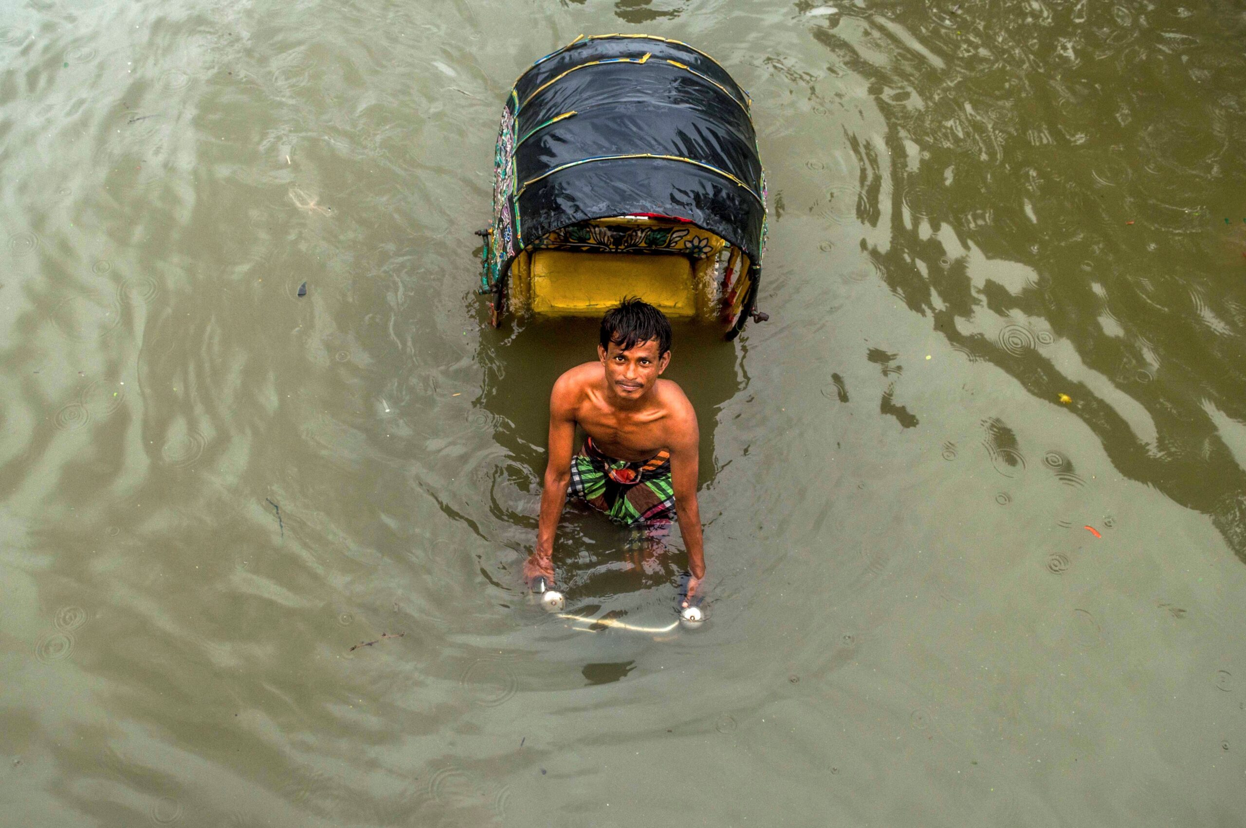 Kazi Jahirul Islam — Chittagong, Bangladesh. During the rainy season, city-dwellers suffer from water-logging problems that disrupt daily transport.