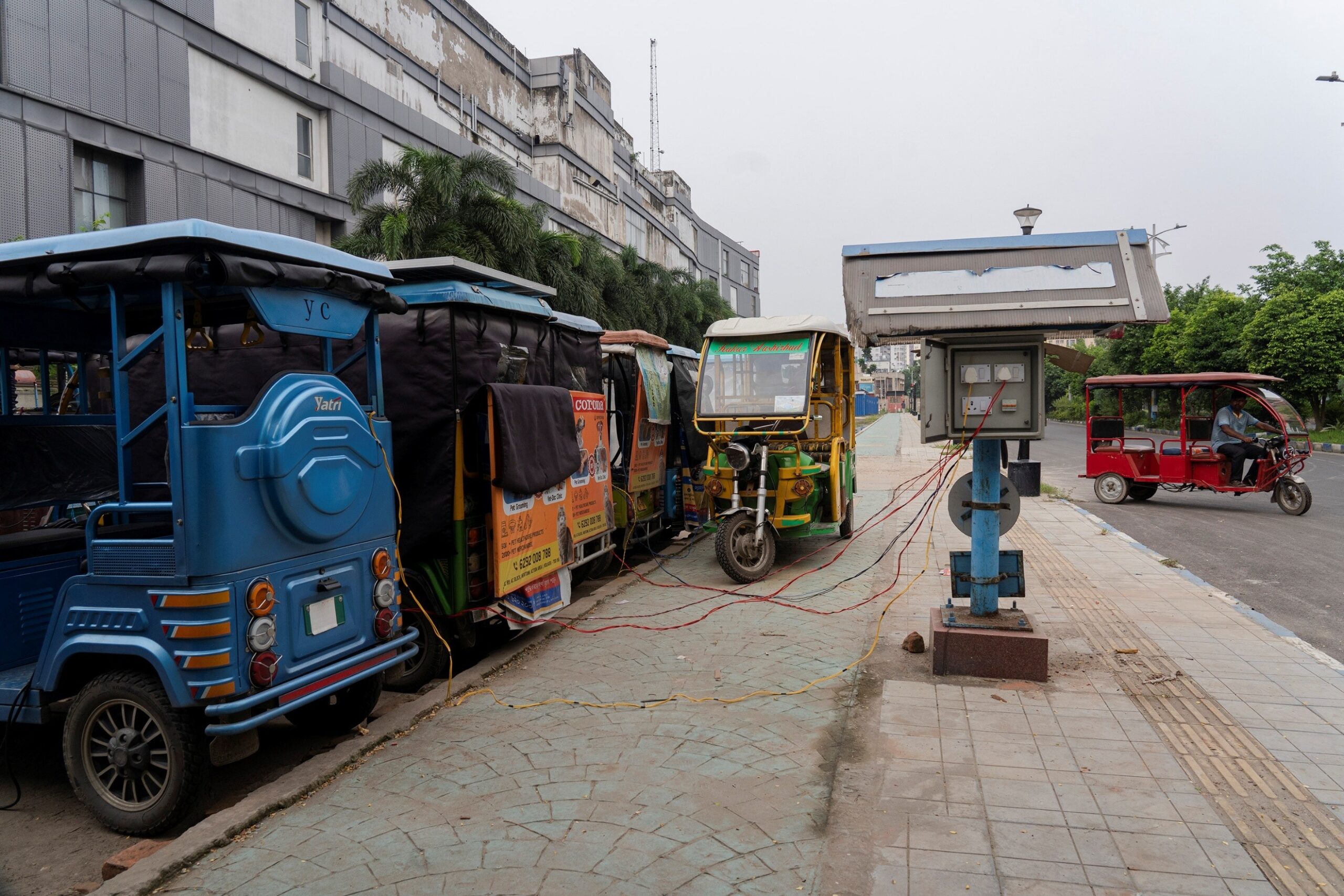 Sudip Maiti — Kolkata, India. Battery operated three-wheelers are getting recharged from a public recharge point in Kolkata.
