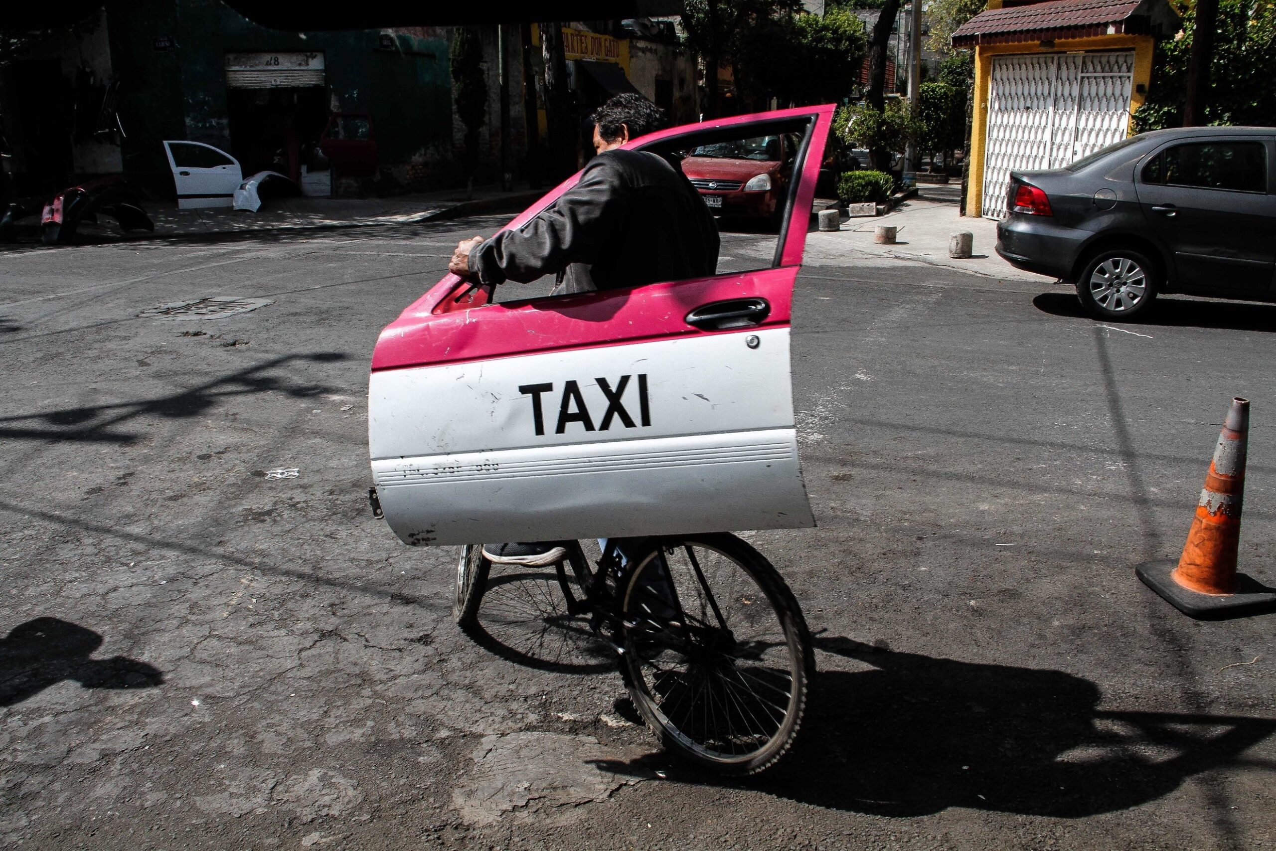 José Luna — Mexico City, Mexico. A couple travel by bicycle with a basket balanced on the head, in Colonia Guerrero.
